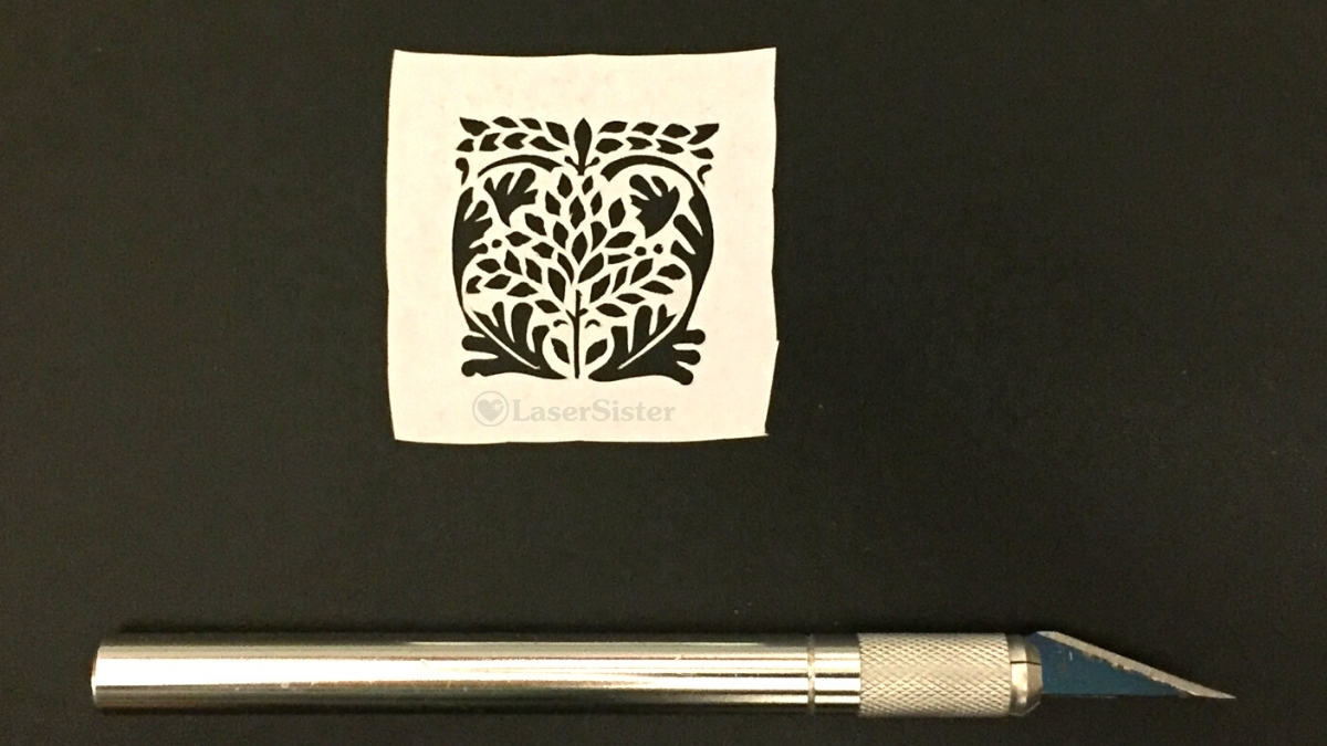 Leaf heart papercut with horizontal scalpel for scale - Kay Vincent - LaserSister