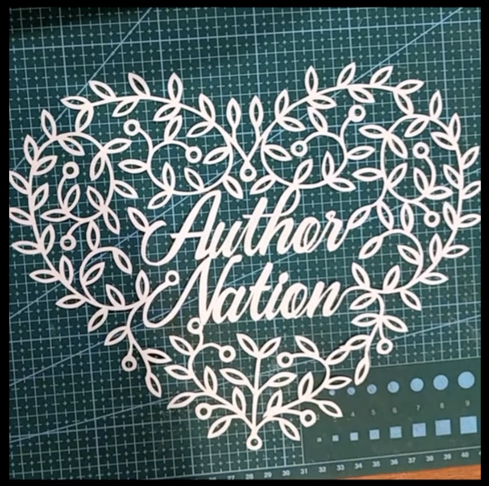 filigree valentine heart featuring the words "Author Nation" and swirling vines and leaves: hand-cut papercut by LaserSister Kay Vincent