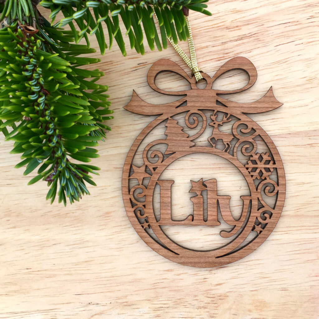 filigree Christmas tree bauble by LaserSister - Kay Vincent- lily with wood background