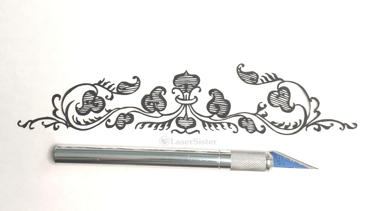 ornate leaf border papercut - horizontal with scalpel for scale - Kay Vincent - LaserSister