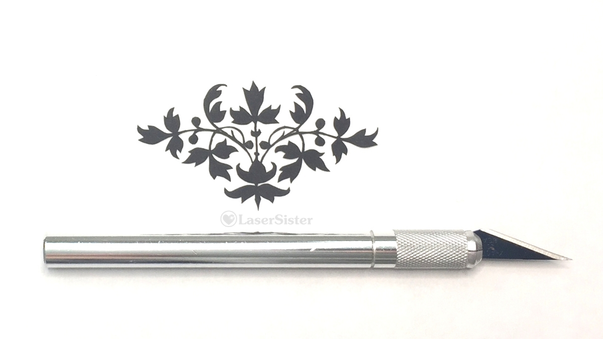 papercut 632 delicate leaves - horizontal with scalpel for scale - LaserSister - KayVincent