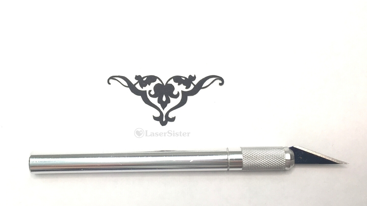 triangle swag papercut - horizontal with scalpel for scale - Kay Vincent LaserSister