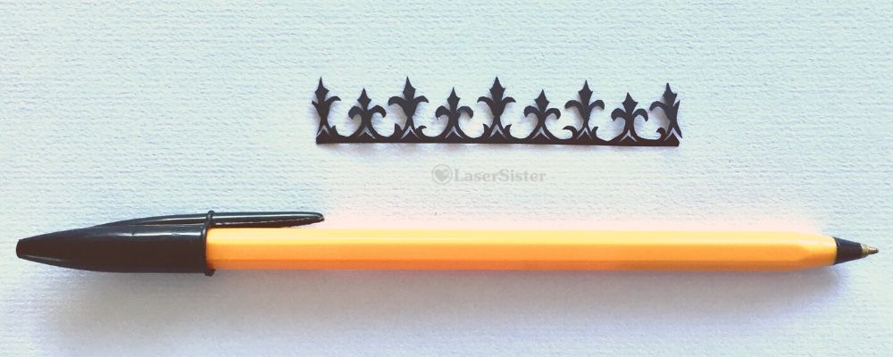 papercut k126 - fleurs de lys with pen for scale - LaserSister - Kay Vincent wm