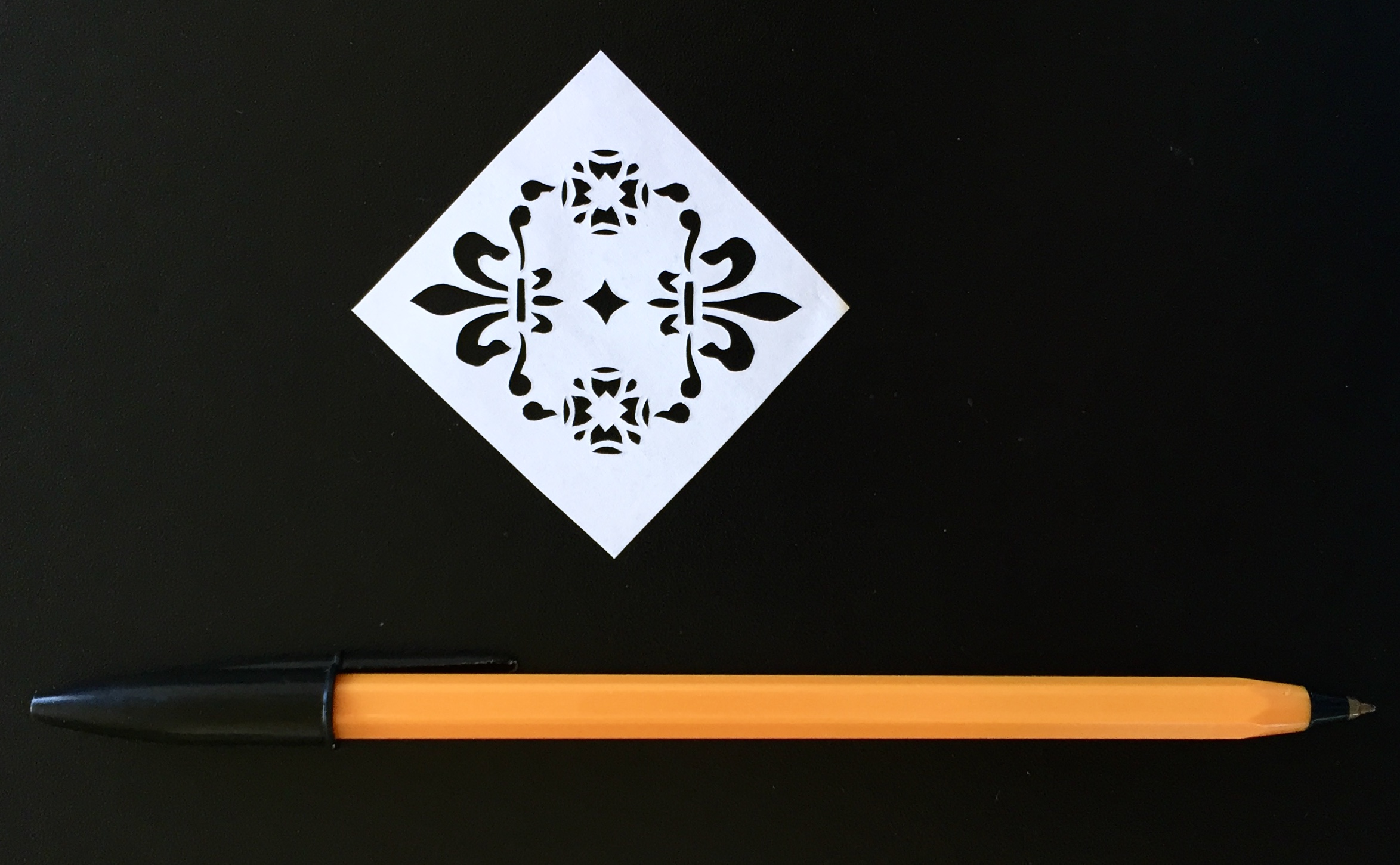 papercut k703 - flower and fleur de lys with pen for scale - LaserSister - Kay Vincent