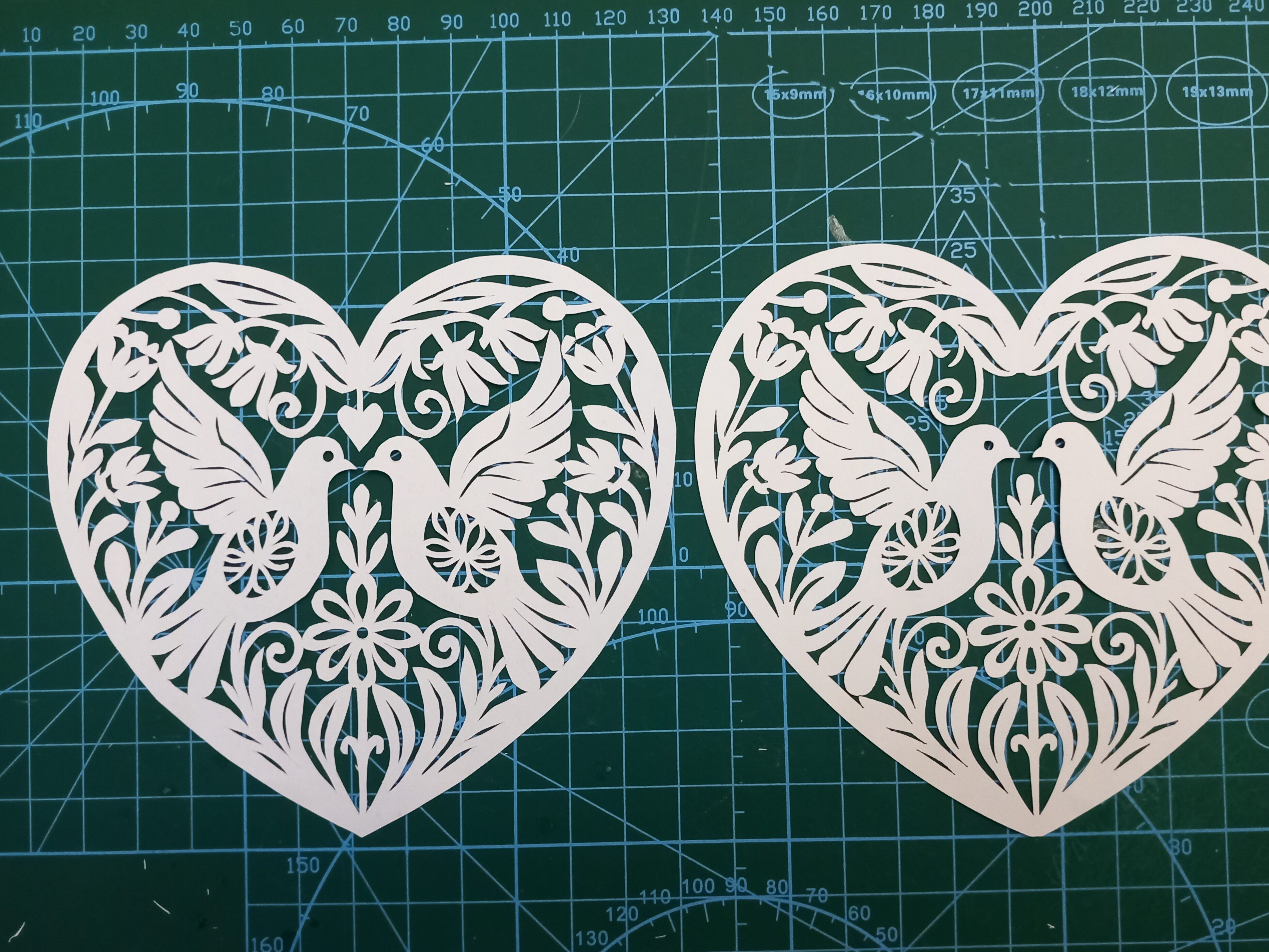 valentine heart and doves papercut comparing hand-cut and laser-cut versions (hand-cut closeup)